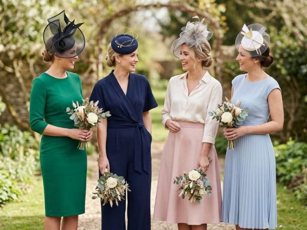 Elegant bridesmaids wearing modern fascinators at a luxury Chicago rooftop wedding venue during sunset