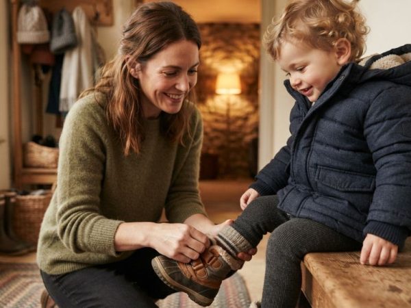 Parent dressing a toddler in comfortable cold-weather clothing